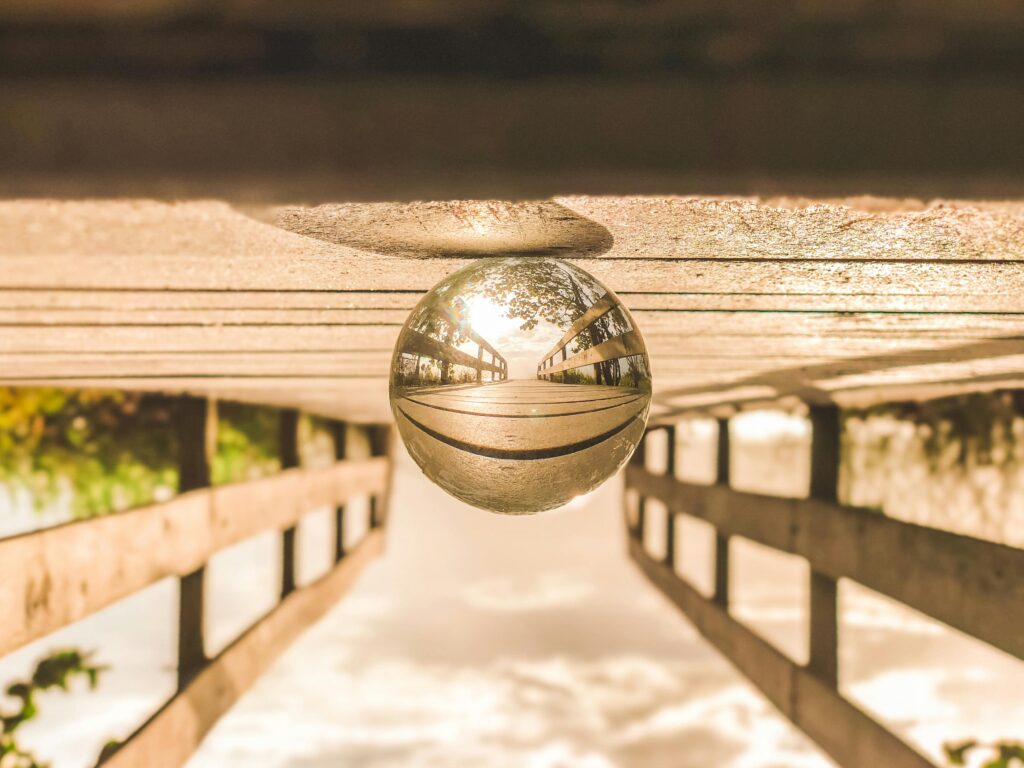 Artistic reflection of a bridge captured in a glass sphere, showcasing a creative perspective.